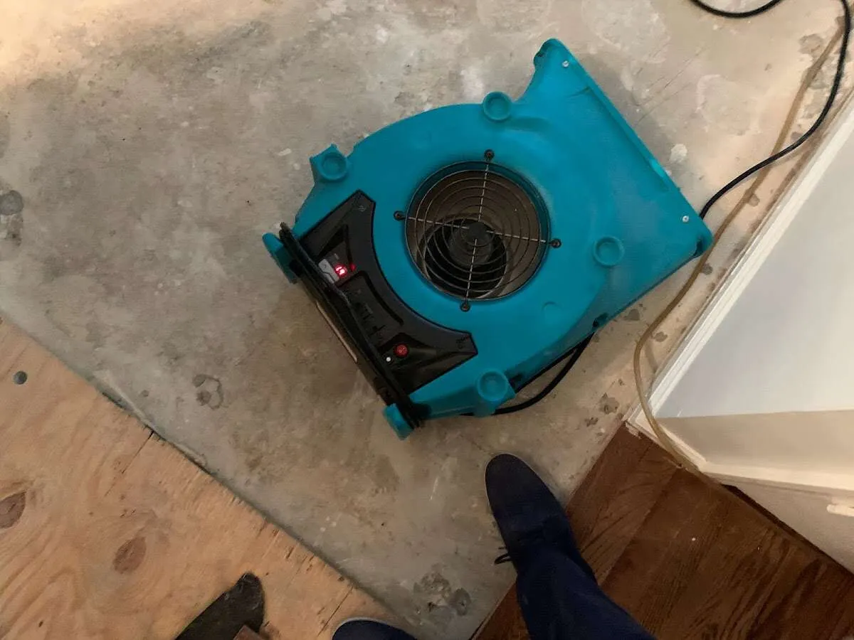 Air mover drying subfloor during Commercial Water Damage Restoration in Sandersville